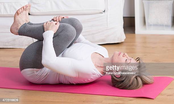 mature woman practicing pilates